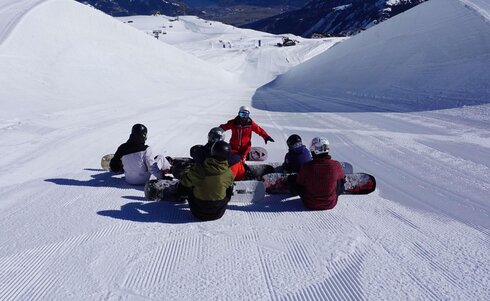 Gruppe von Snowboardern mit Snowboardlehrer